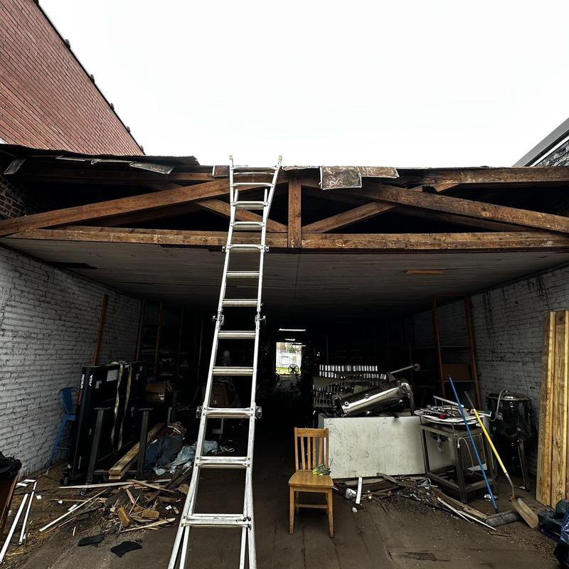 Wooden roof trusses with collapsed roofing and ladder Wooden roof trusses with collapsed roofing and ladder