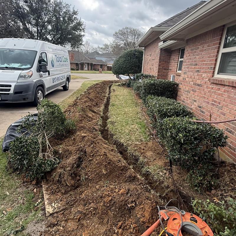 Water line trench dug beside house yard in Hurst TX