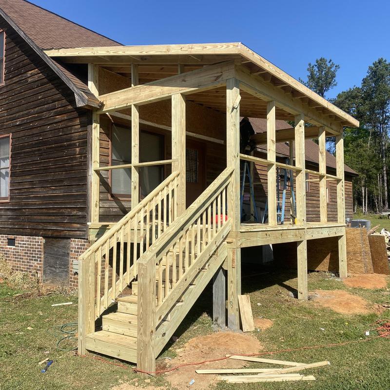 Wooden porch deck construction with stairs addition