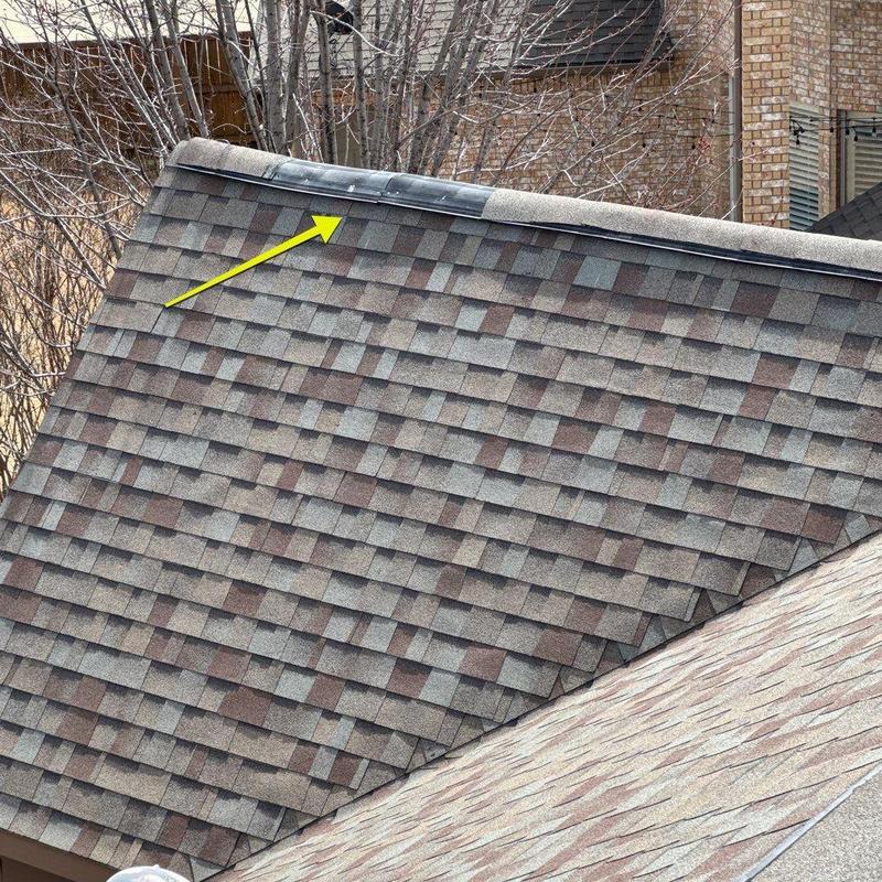 Roof ridge cap with nailed shingles and metal flashing
