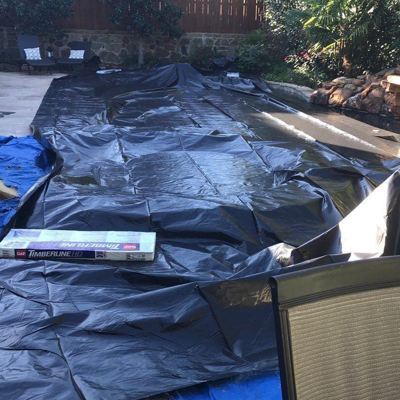 Roof shingles box on pool cover in backyard patio Roof shingles box on pool cover in backyard patio
