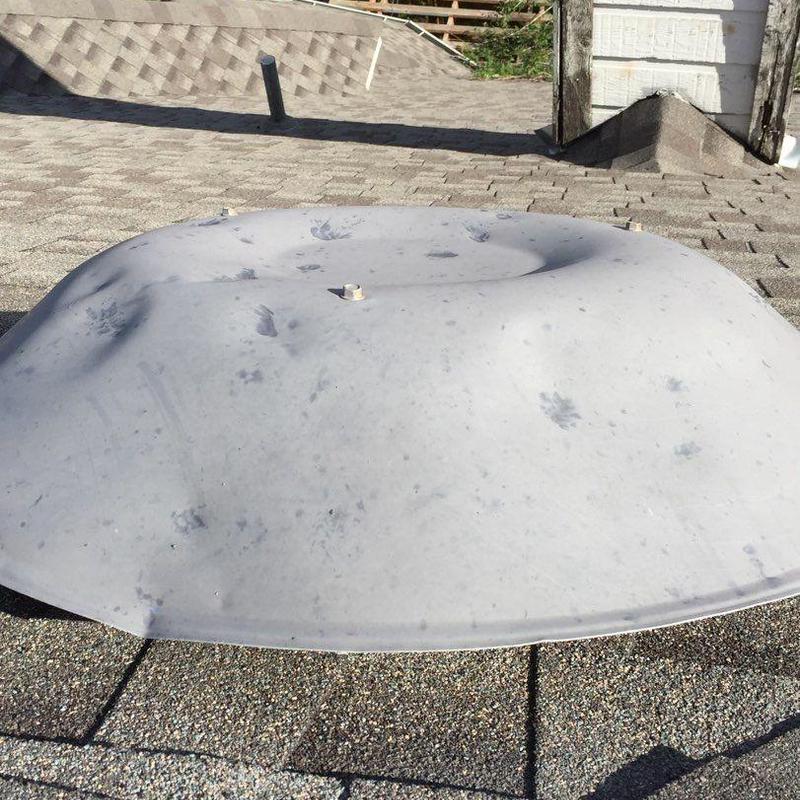 Roof vent cover with hail damage on asphalt shingles Roof vent cover with hail damage on asphalt shingles