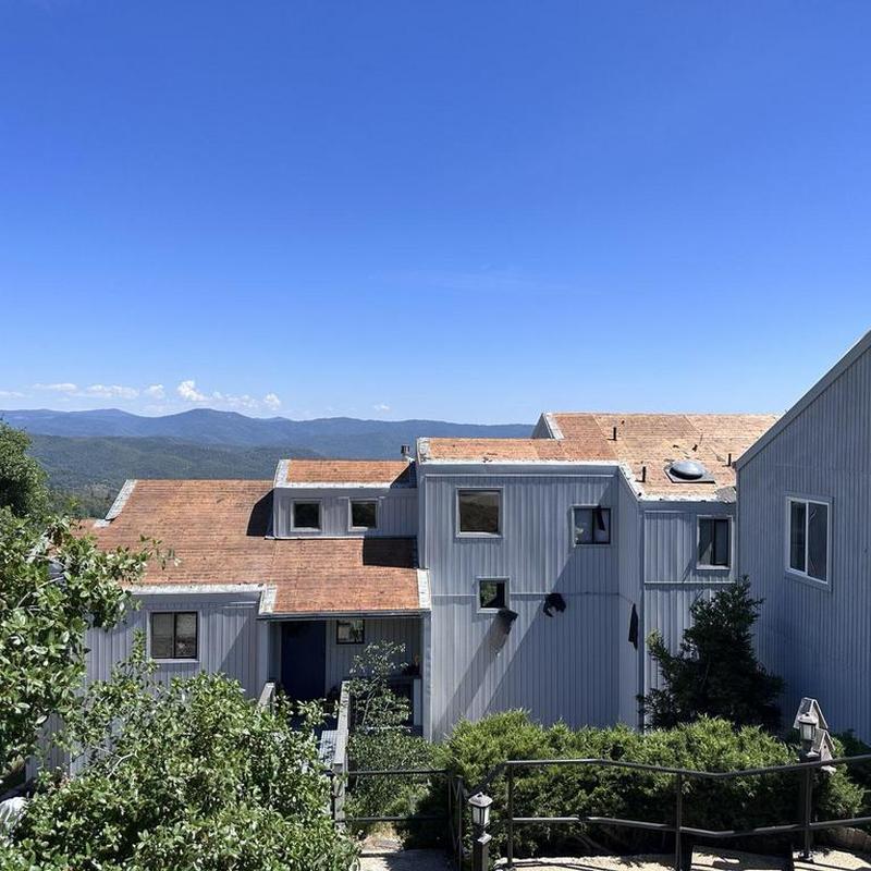 Old asphalt roof with worn shingles on home exterior