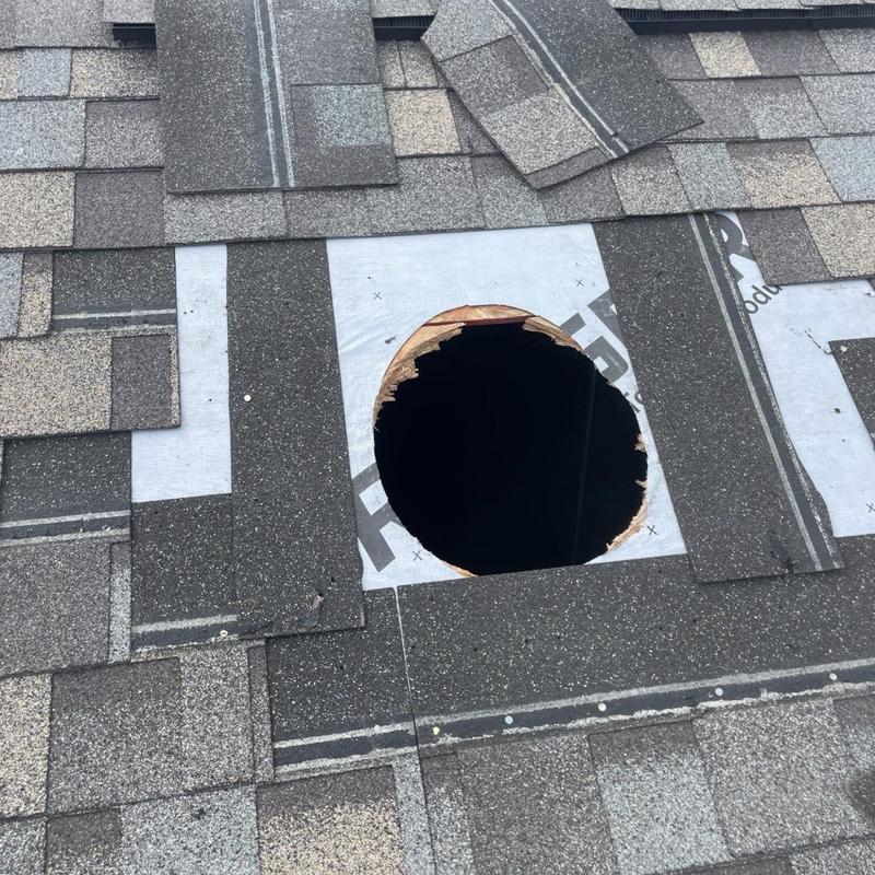 Roof vent opening with surrounding asphalt shingles removed