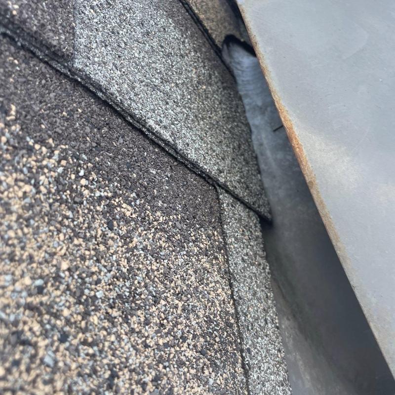 Asphalt shingle roof edge with metal flashing close-up