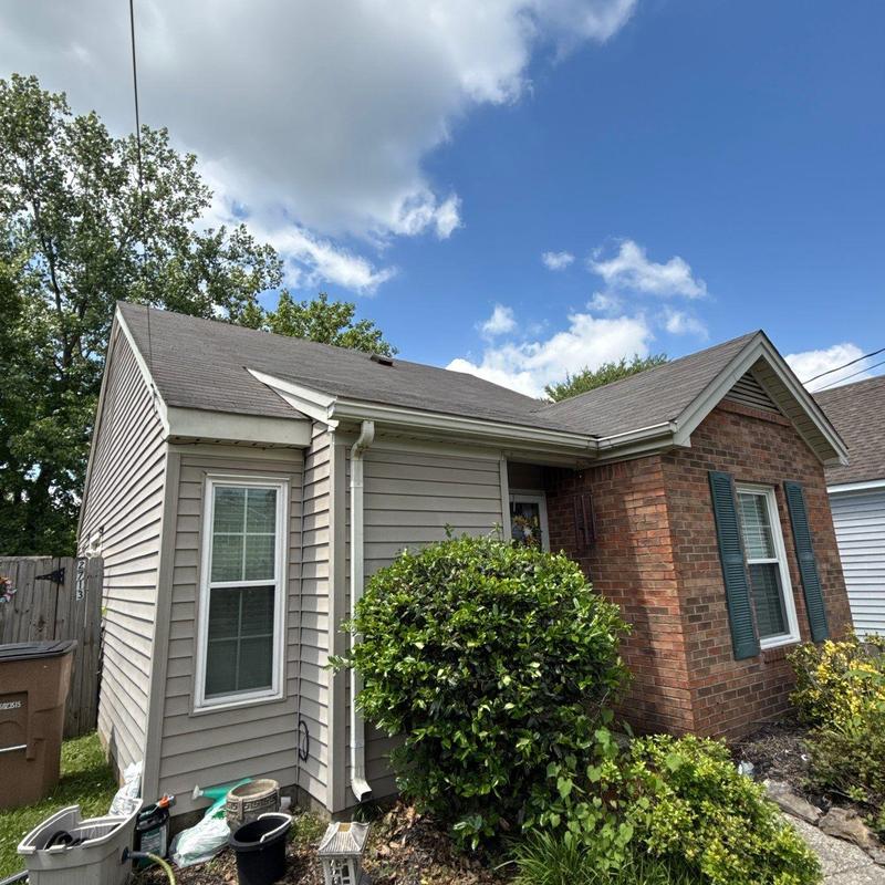 Asphalt shingle roof with visible wear and debris