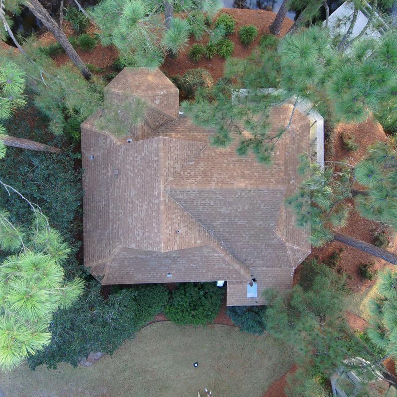 Shingle roof aerial view with surrounding pine straw mulch Shingle roof aerial view with surrounding pine straw mulch