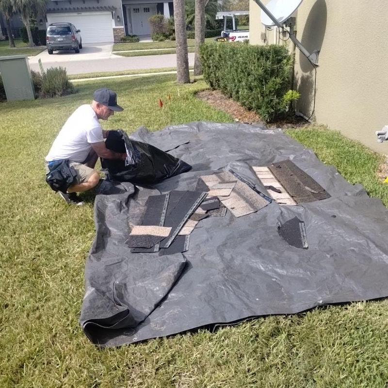 Roof shingles removal and debris cleanup on tarp