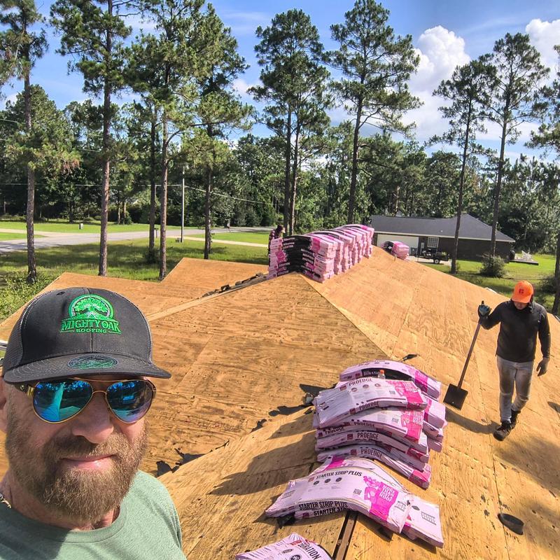 Roof decking with bundled shingles prepped for installation