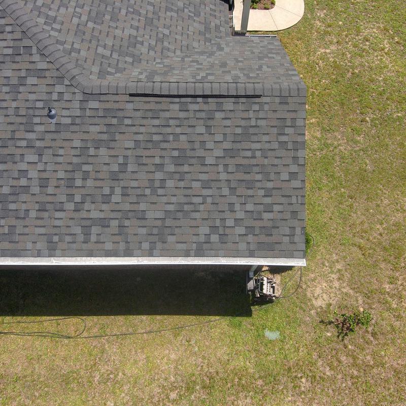 Asphalt shingle roof showing storm damage and wear