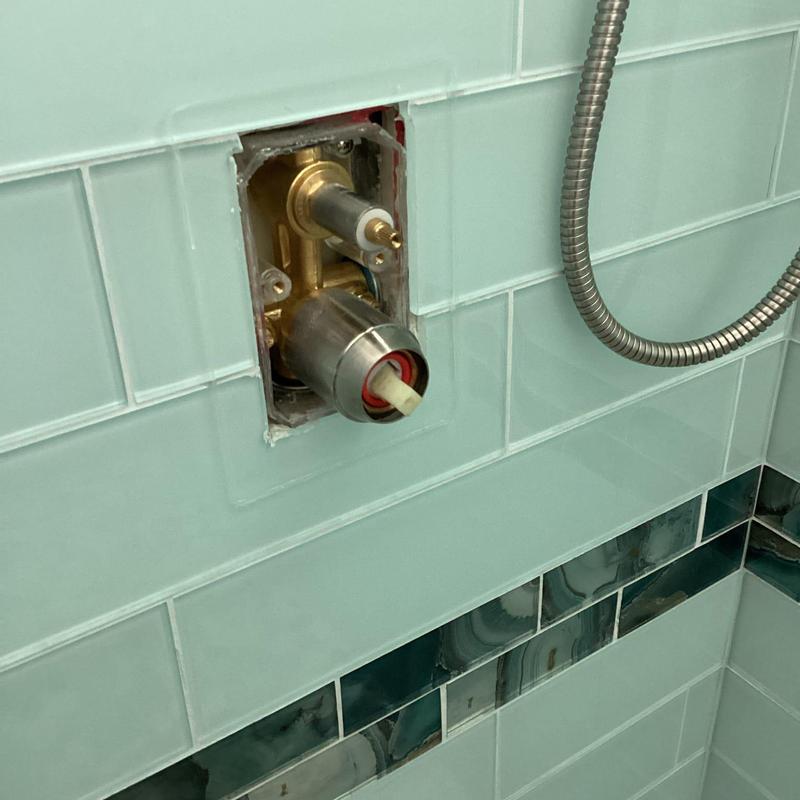 Shower valve cartridge replacement in tiled shower wall