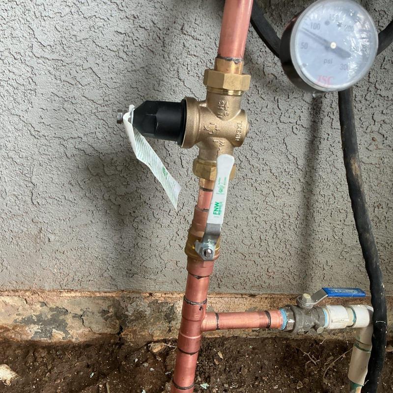 Mainline riser with valve and pressure gauge in wall