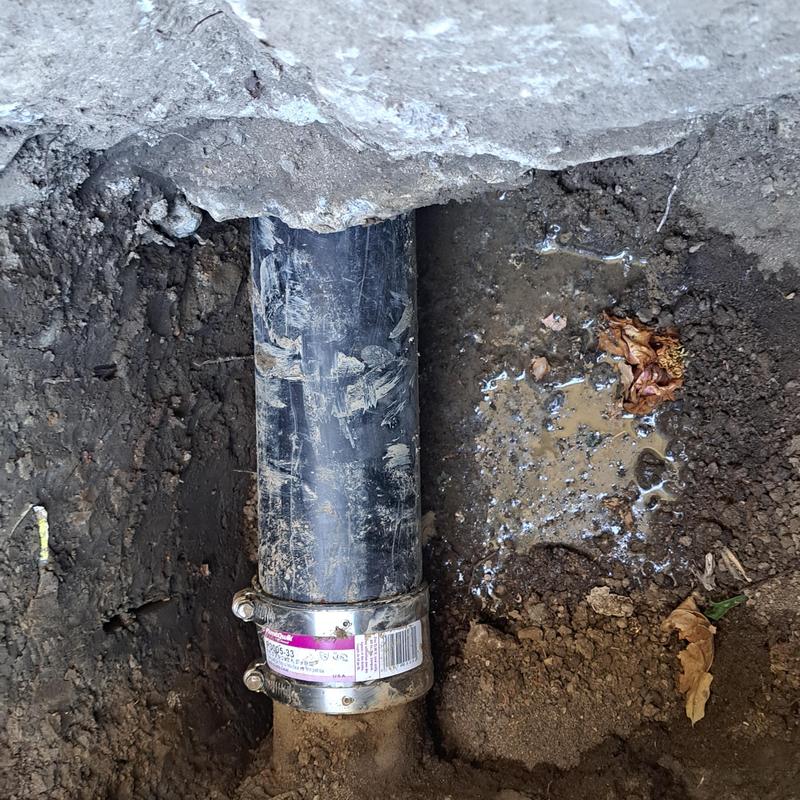 Sewer pipe section with clamp under house repair