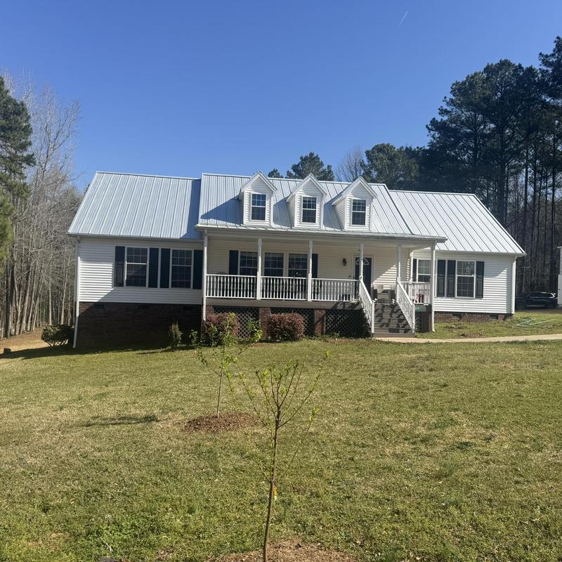 Standing seam metal roof on white home in Great Falls SC