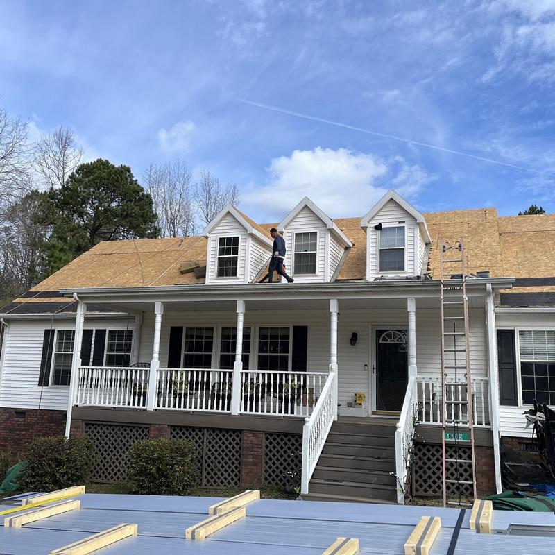 Standing seam metal roof decking installation on house