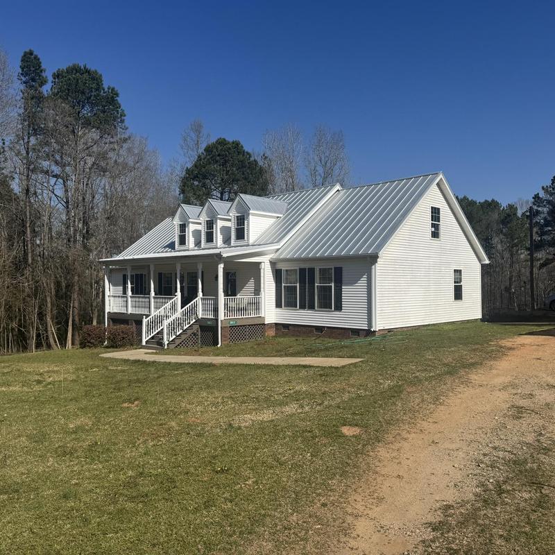 Standing seam metal roof on rural white home