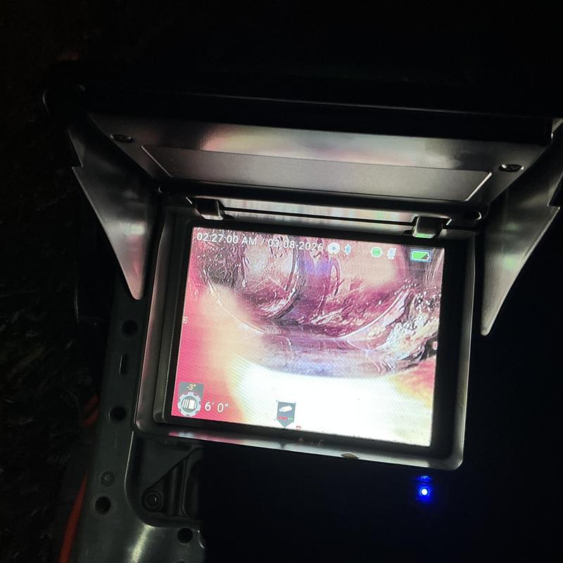 Drain pipe inspection showing root intrusion on monitor