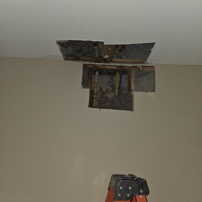 1 inch PEX piping in ceiling with cut drywall panels