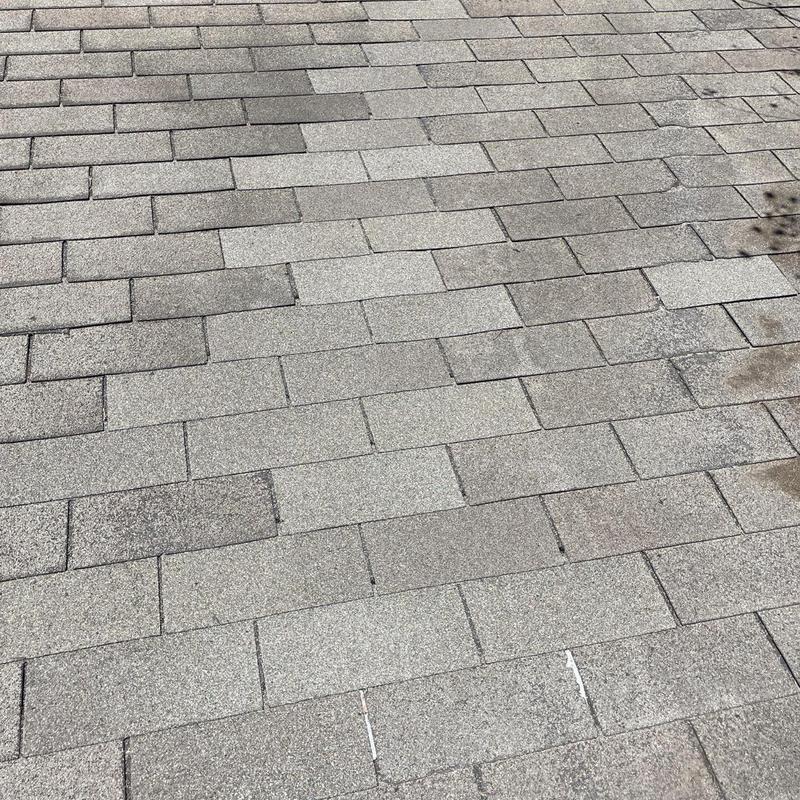 Asphalt shingle roof with repaired sections