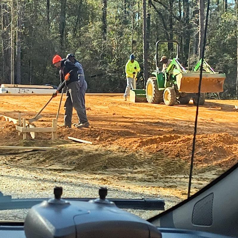 Construction site soil grading and preparation with tractor