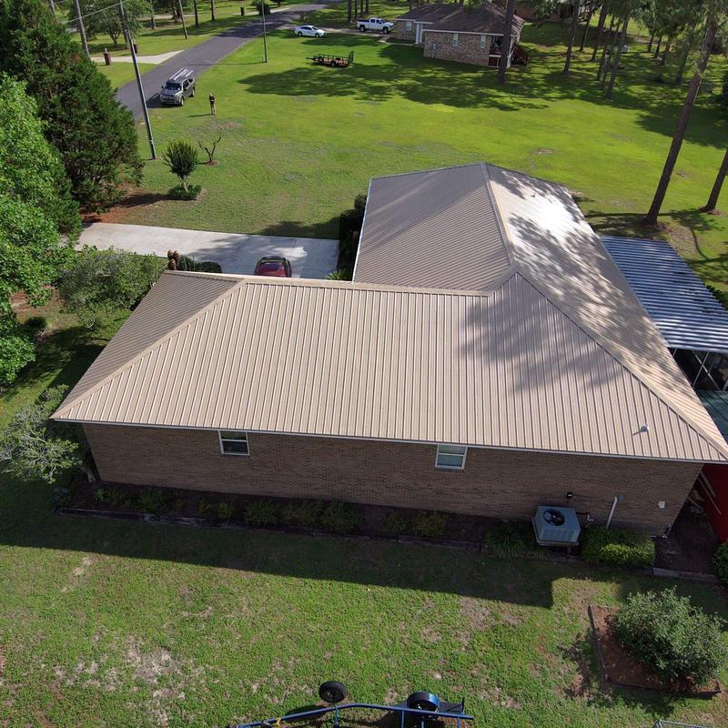 Metal roof installation on brick house in DeFuniak Springs