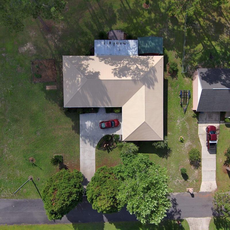 Metal roof installation on residential house driveway