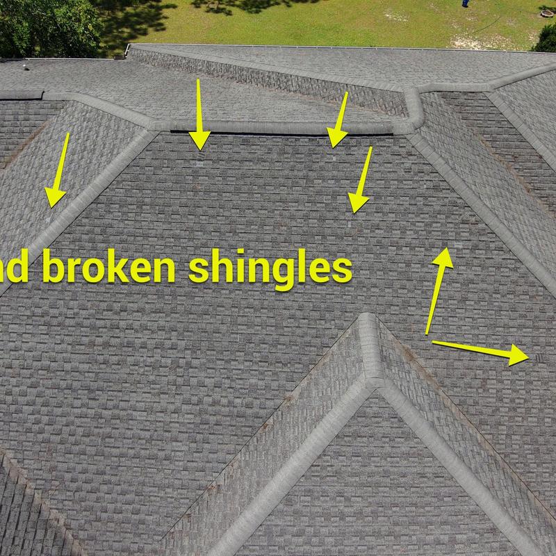 Asphalt shingles with wind damage and broken areas