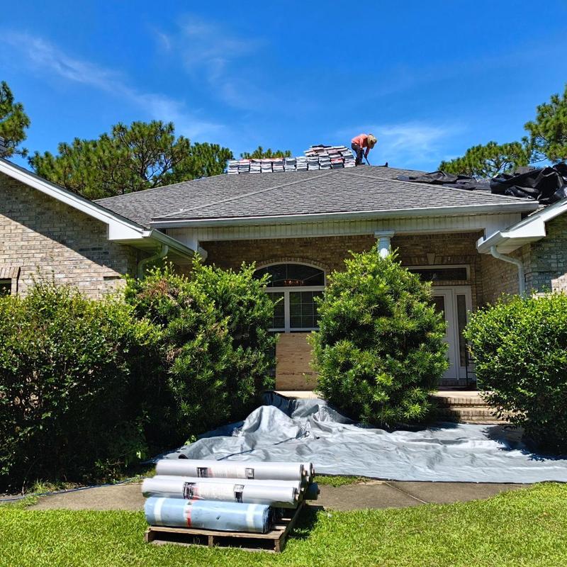 Roof shingles stacked for full replacement on house roof
