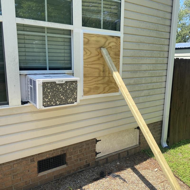 Window repair with plywood board and wooden brace Window repair with plywood board and wooden brace