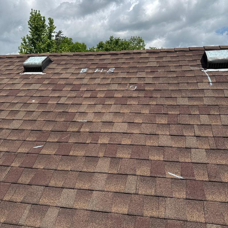 Asphalt shingle roof with hail damage markings