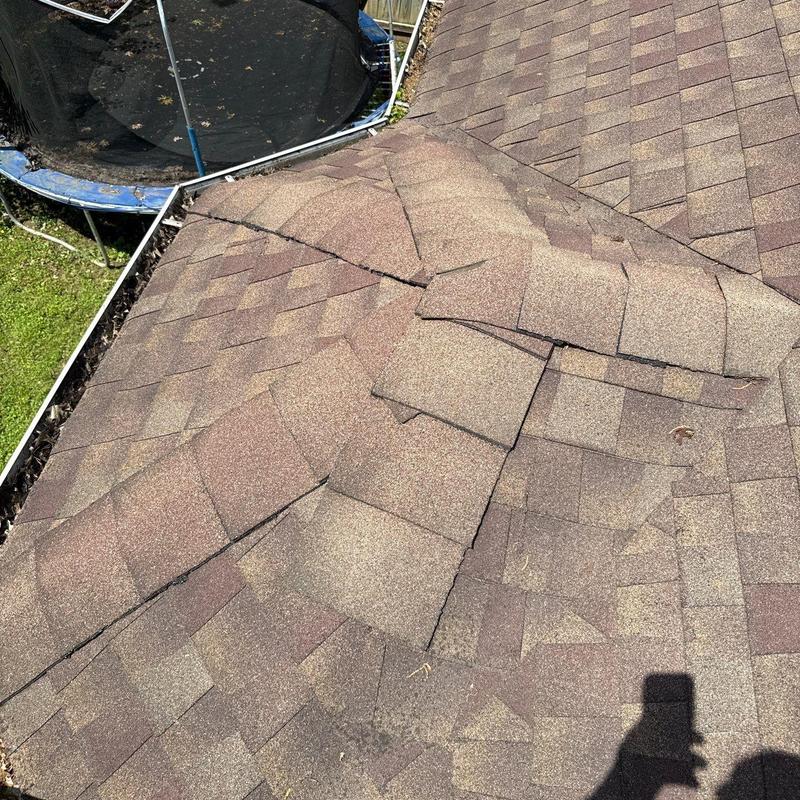 Asphalt shingle roof with hail damage and flashing issues