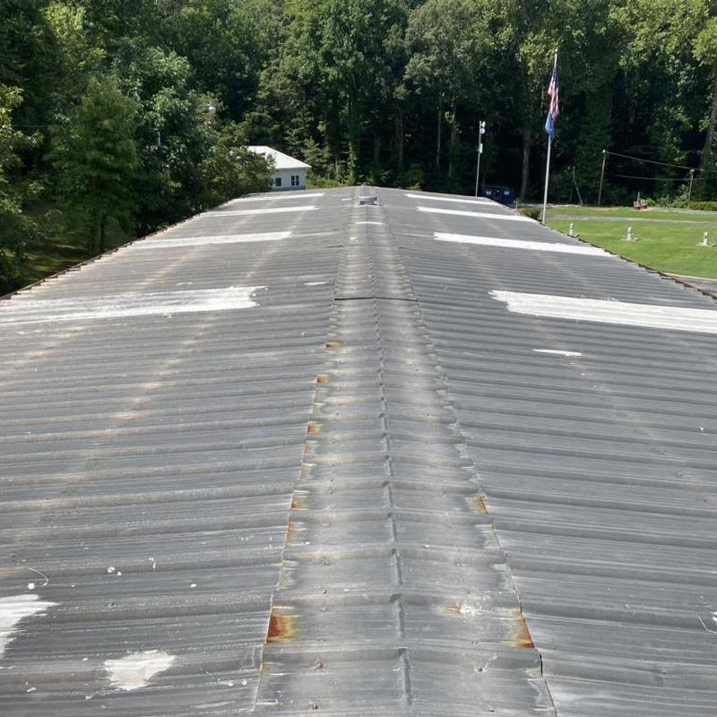Metal roof panels with rust spots and patches Metal roof panels with rust spots and patches