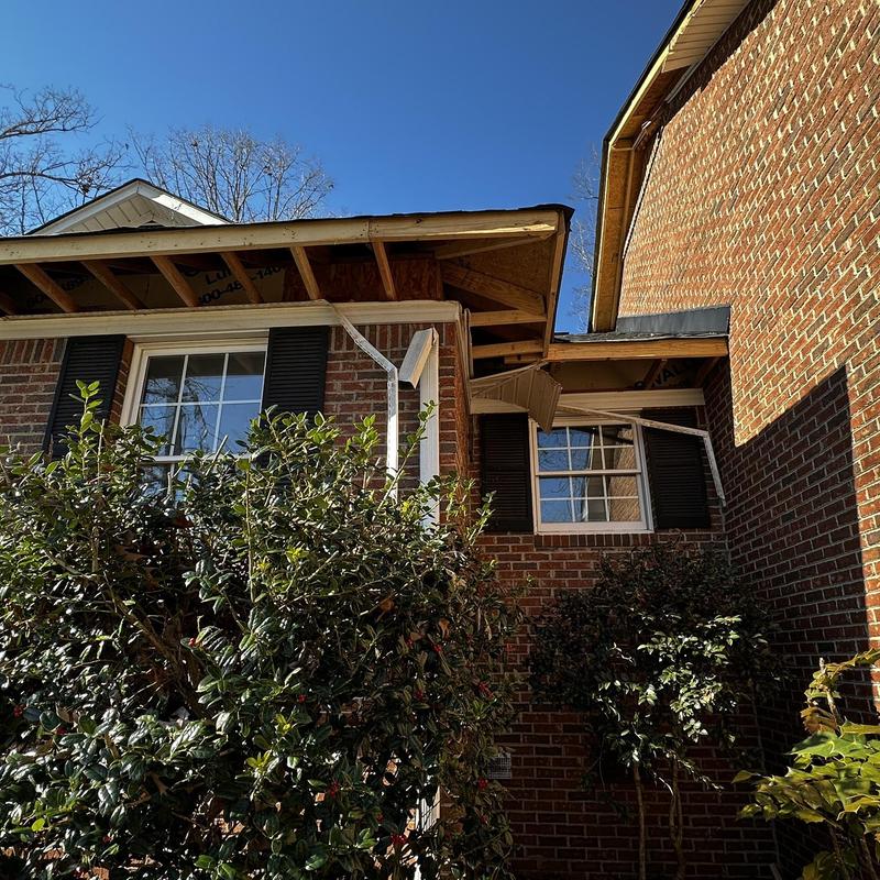 Exposed roof framing and soffit on brick home exterior Exposed roof framing and soffit on brick home exterior