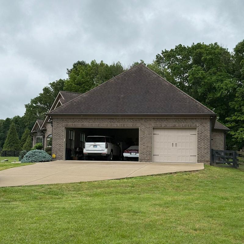 Asphalt shingle roof with hail damage on residential garage
