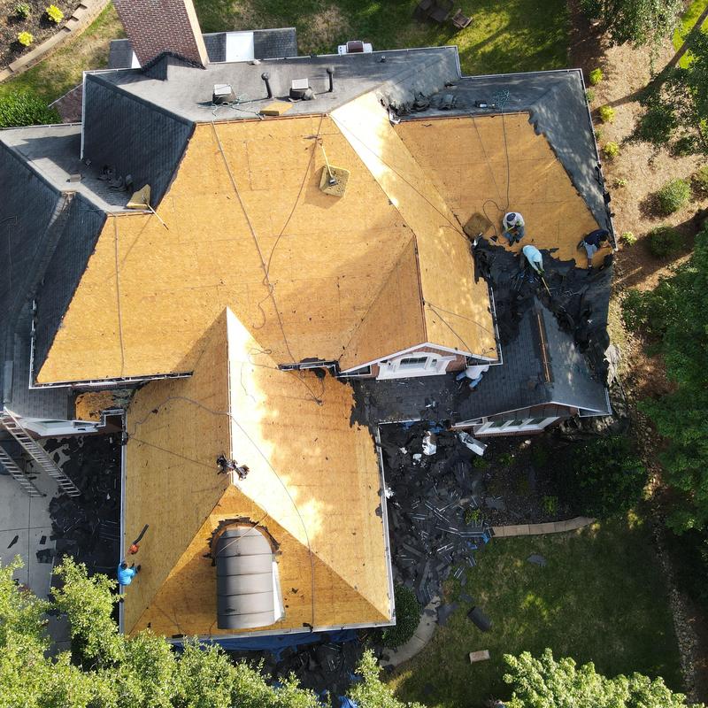 Roof decking replacement with crew working on shingles Roof decking replacement with crew working on shingles