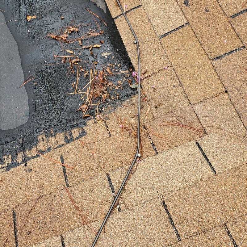 Asphalt roof shingles with debris and sealant edge