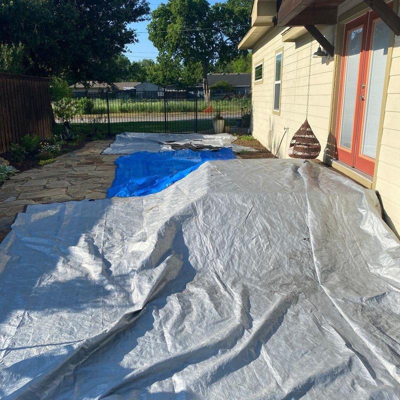 House exterior patio area covered with protective tarps House exterior patio area covered with protective tarps