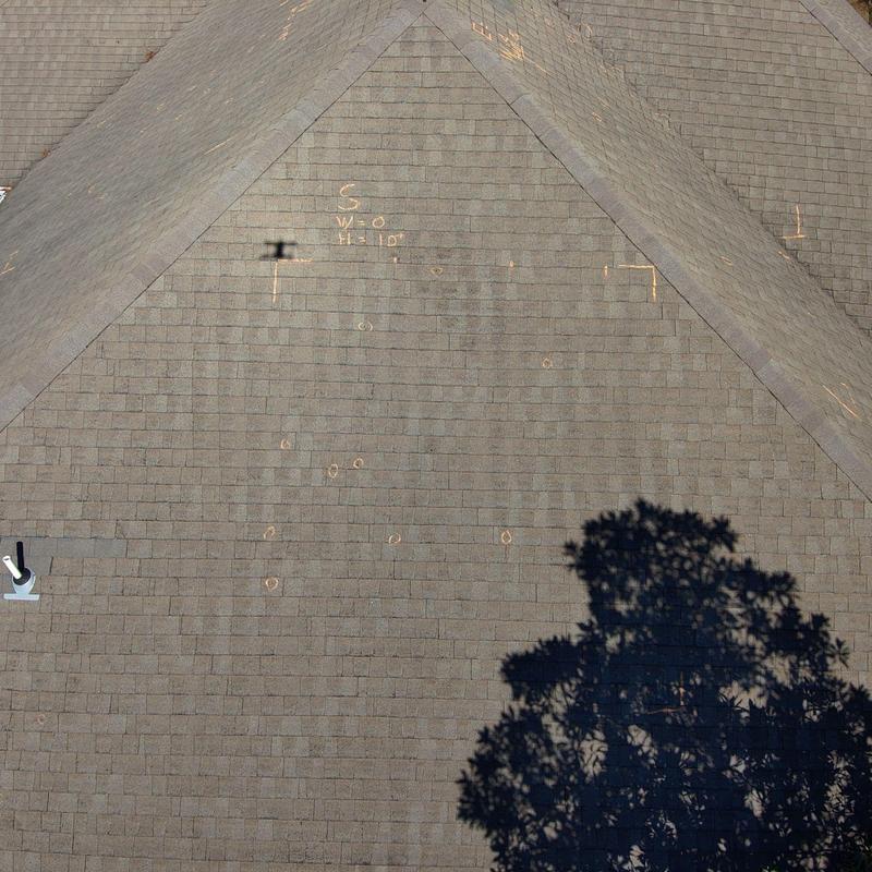 Asphalt shingles with chalked hail and wind damage markings
