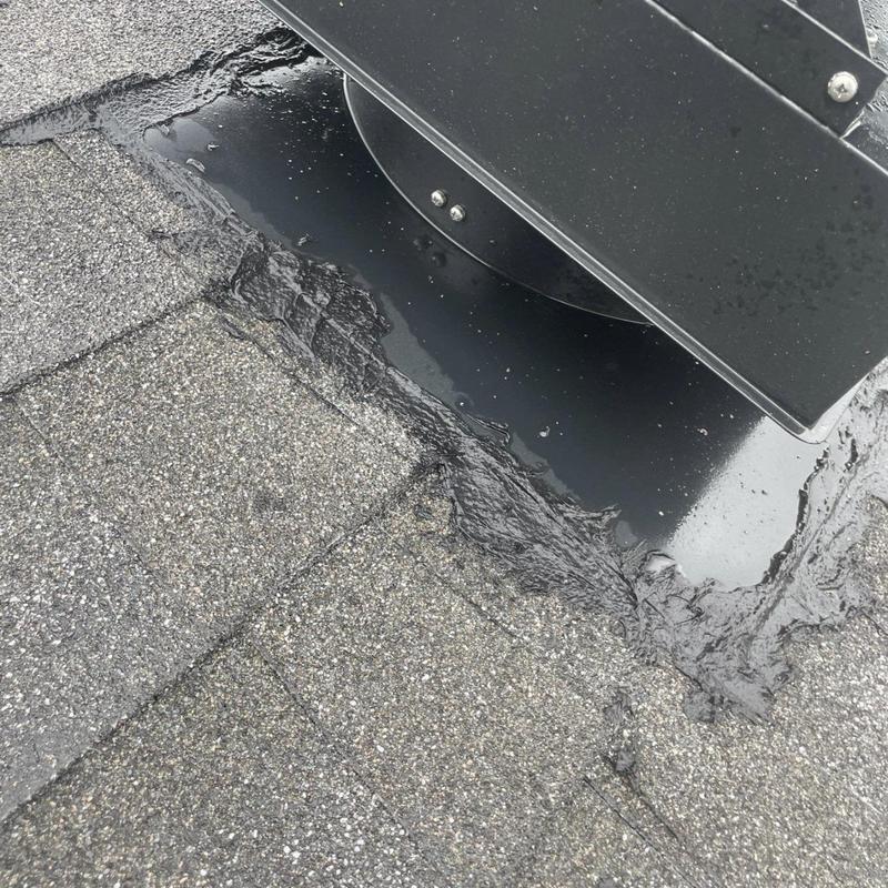 Roof vent flashing with deteriorated sealant on shingles