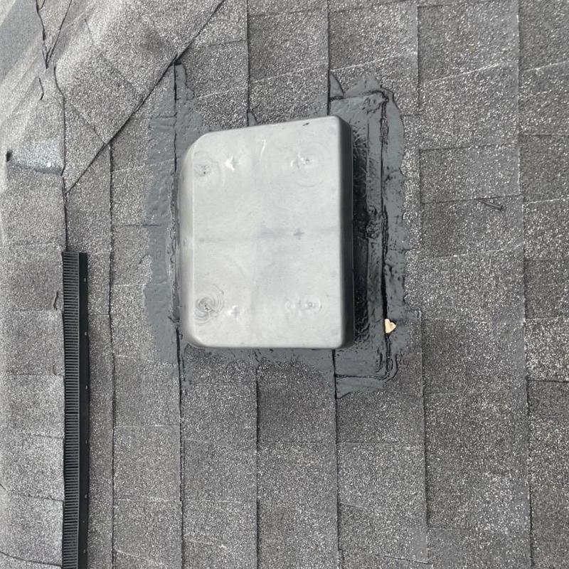 Roof vent flashing with roof cement sealant on shingles