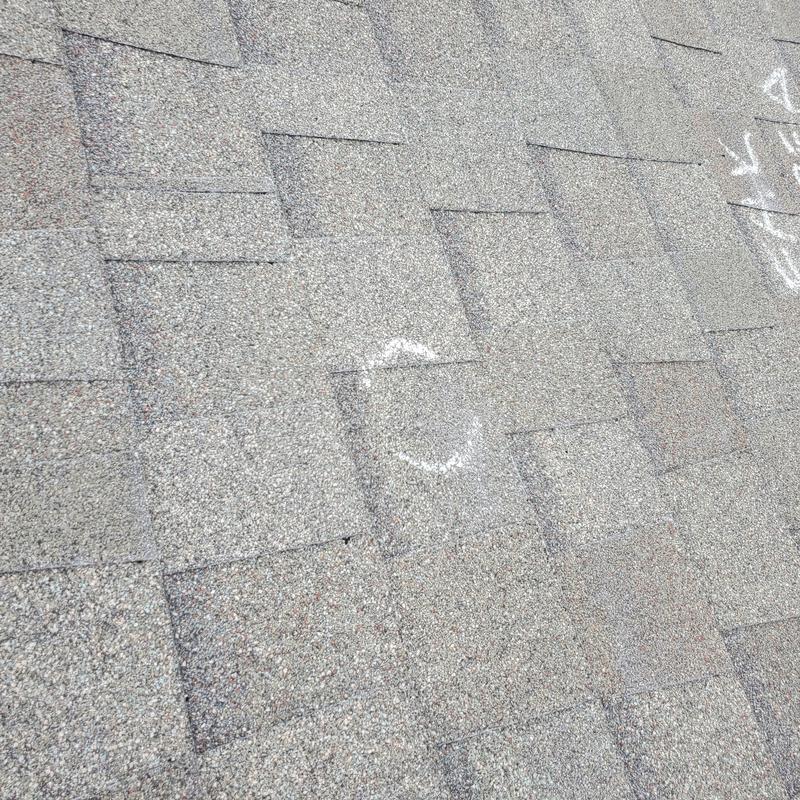Roof shingles with hail damage markings in Terrell, TX