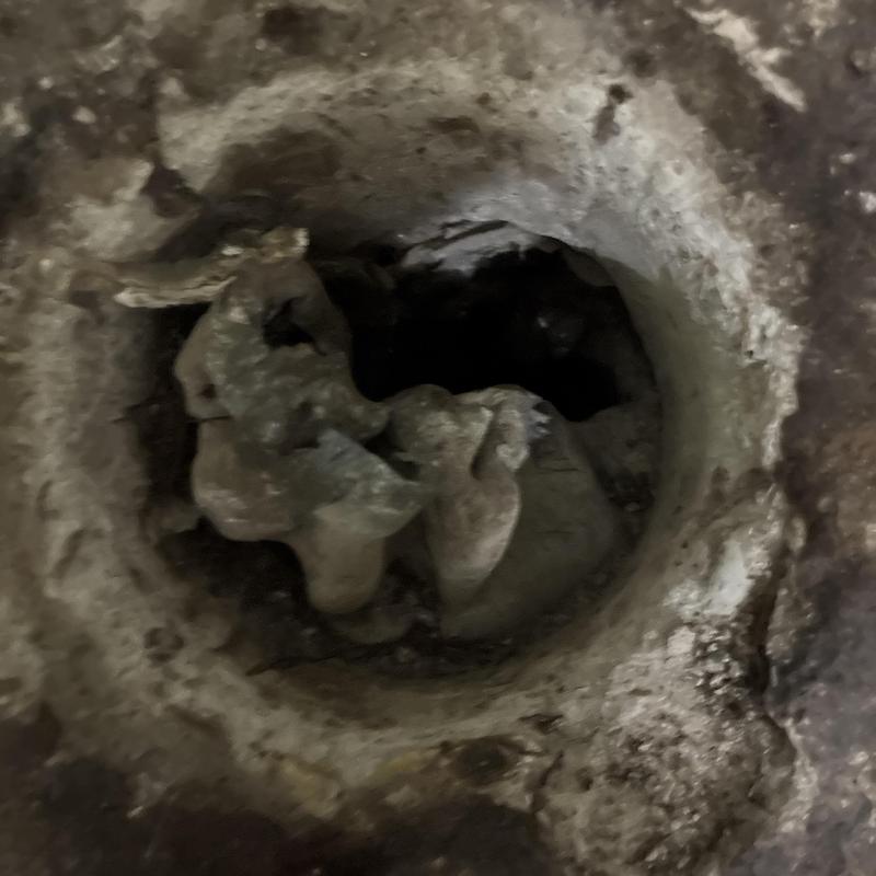 Toilet flange and drain pipe in historic house floor