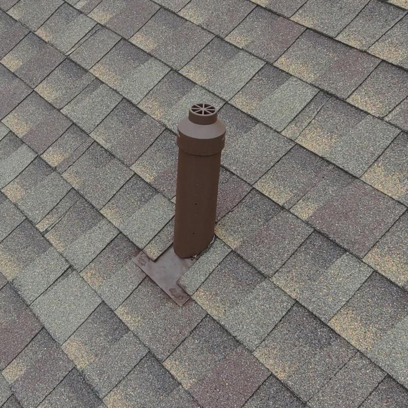 Custom brown pipe protector on roof shingles