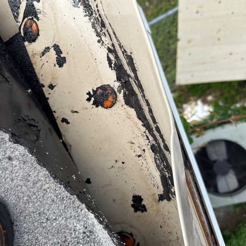 Metal roof edge with corrosion and damaged sealant