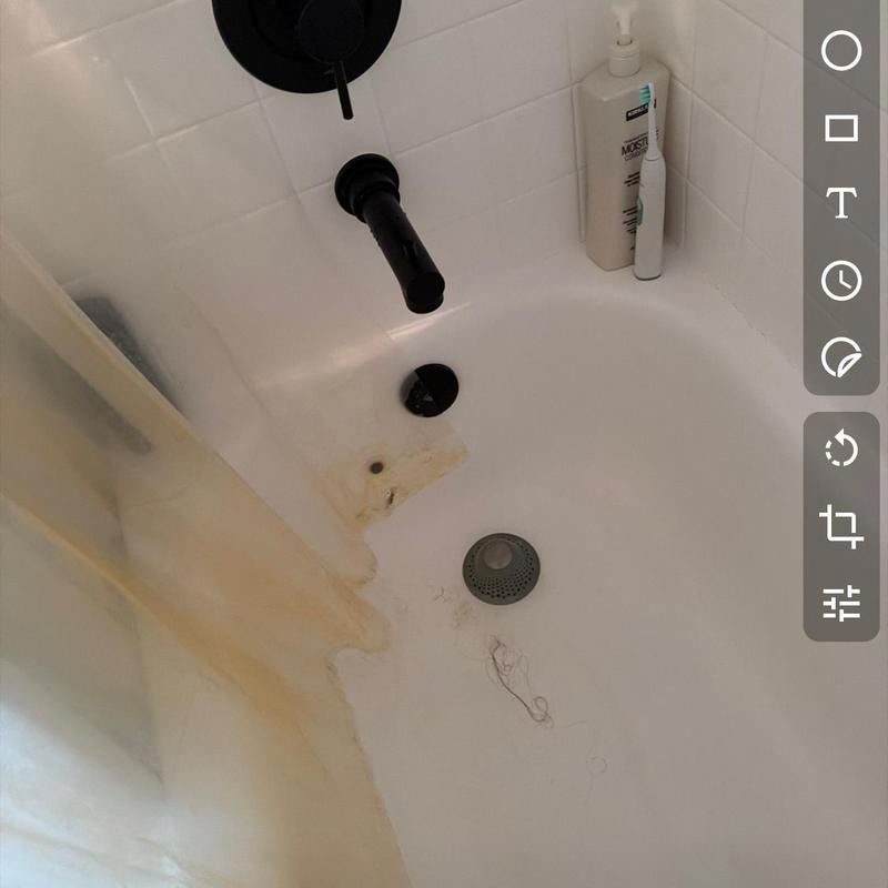Bathroom tub drain clog with stain and hair buildup