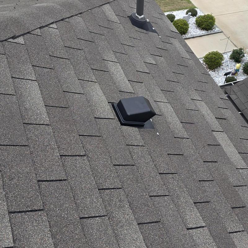 Asphalt shingles roof with vent pipe and storm damage