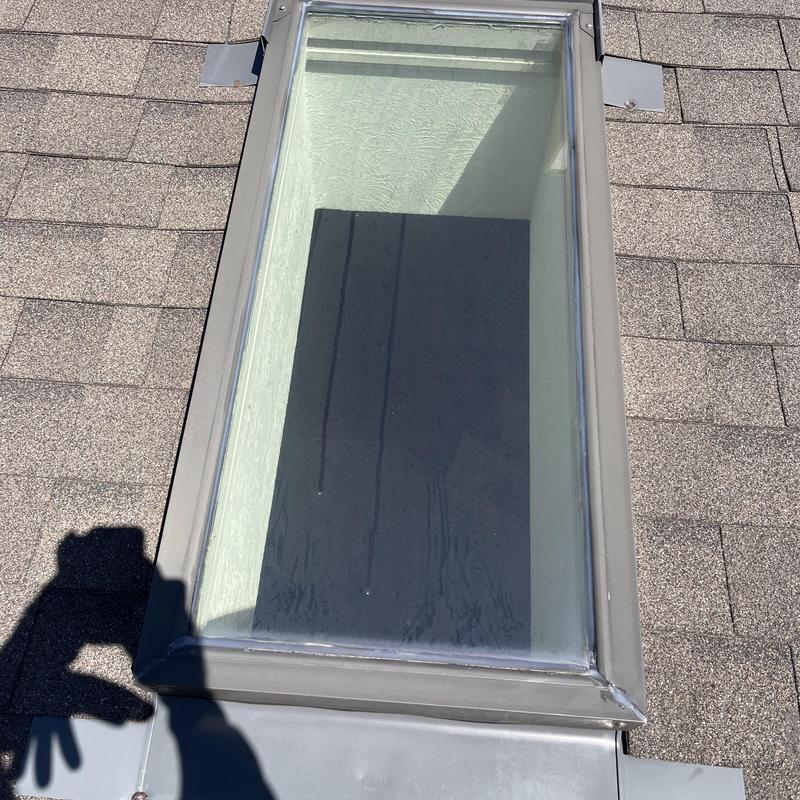 Skylight glass with visible water streaks on roof Skylight glass with visible water streaks on roof