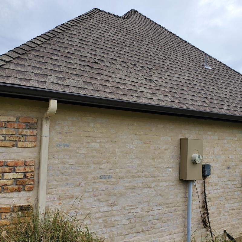 Asphalt shingle roof with hail damage and discoloration