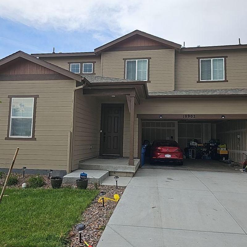 Shingle roof with hail damage and garage driveway Shingle roof with hail damage and garage driveway