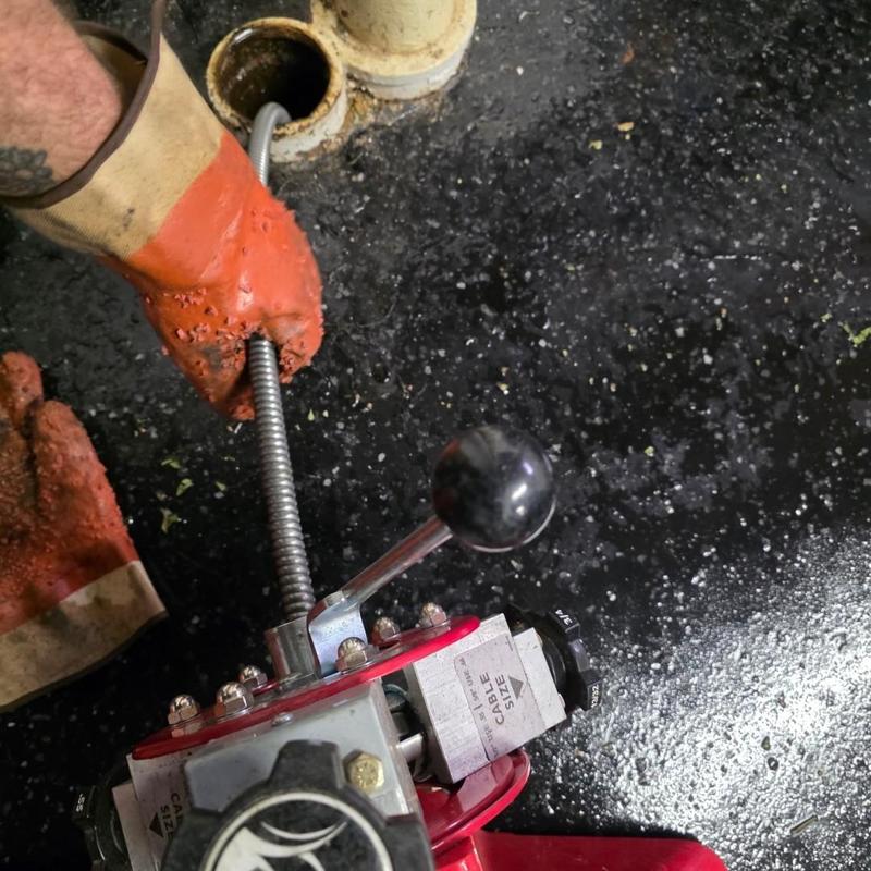 Drain cable clearing tree root blockage in sewer line